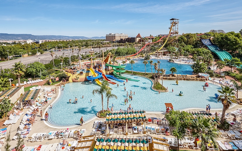 Tallest free fall water slide at Costa Caribe Port Aventura, Spain, with pools and visitors.
