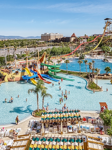 Tallest free fall water slide at Costa Caribe Port Aventura, Spain, with pools and visitors.