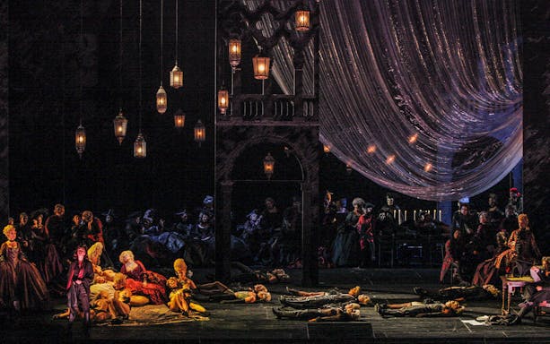 Opera scene from Les Contes d'Hoffmann with performers in period costumes on stage.
