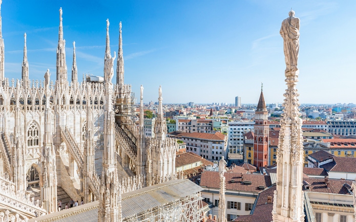 Milan Duomo rooftop view with cityscape in the background.