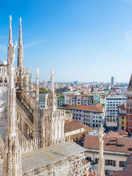 Milan Duomo rooftop view with cityscape in the background.
