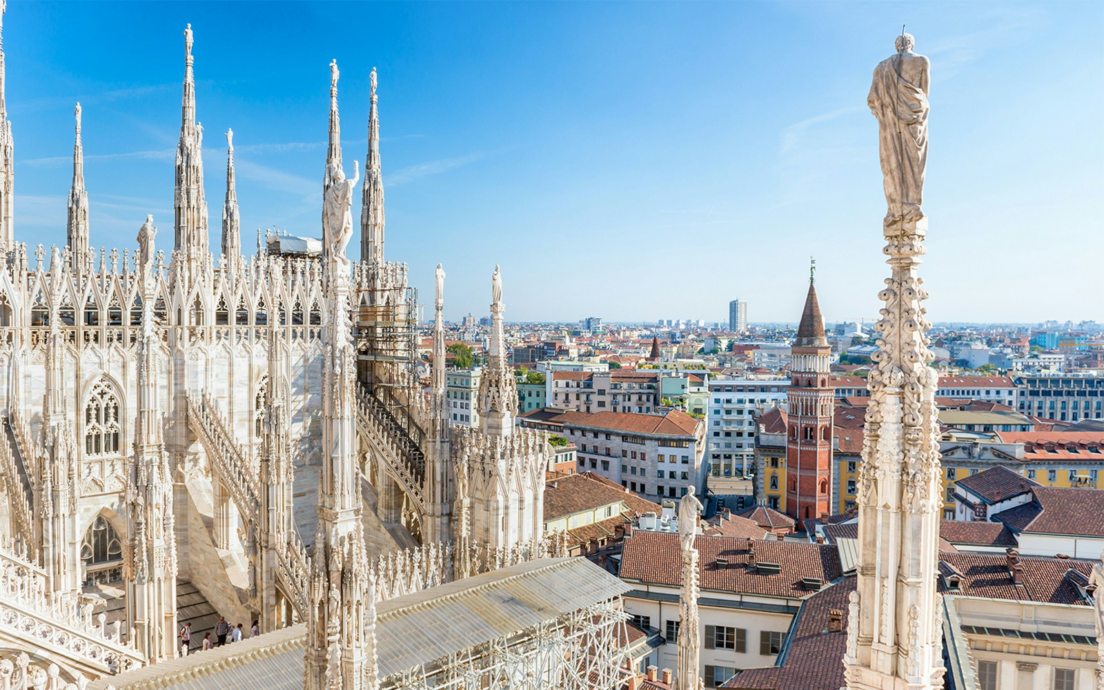 Milan Duomo rooftop view with cityscape in the background.