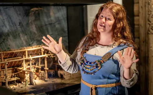 Guide explaining Viking history at The Viking Museum, Stockholm.
