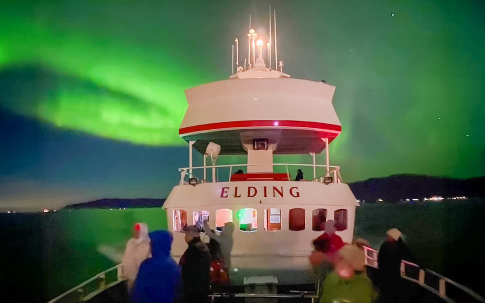 Guests viewing northern lights from a cruise ship deck in Iceland.
