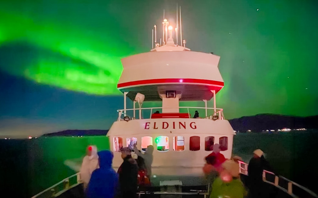 Guests viewing northern lights from a cruise ship deck in Iceland.