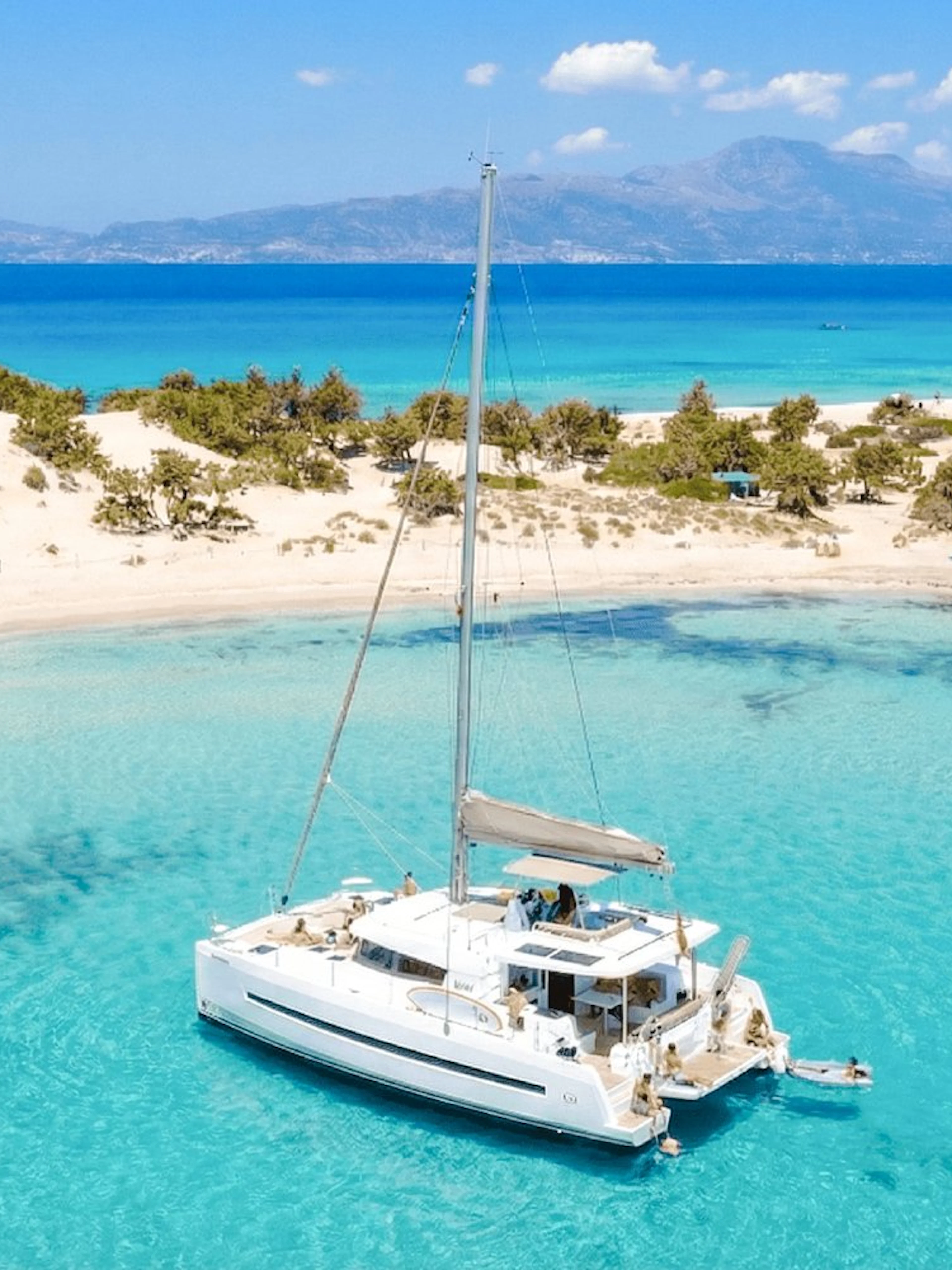 Catamaran anchored in turquoise waters near Chrissi Island, Ierapetra.