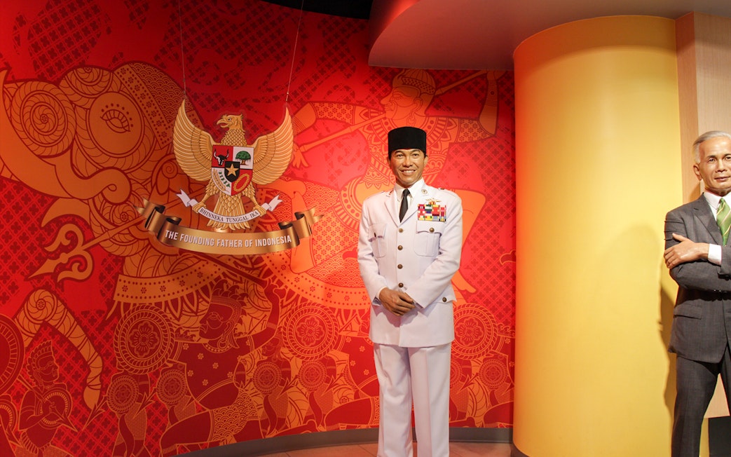 Wax figure in military attire at Madame Tussauds Bangkok with Indonesian emblem background.