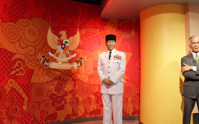 Wax figure in military attire at Madame Tussauds Bangkok with Indonesian emblem background.