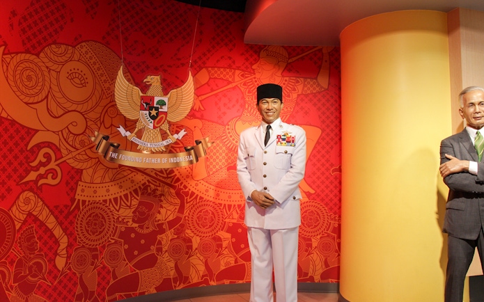 Wax figure in military attire at Madame Tussauds Bangkok with Indonesian emblem background.