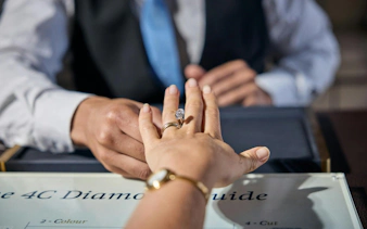 Hand with diamond ring at Royal Diamond Factory tour.