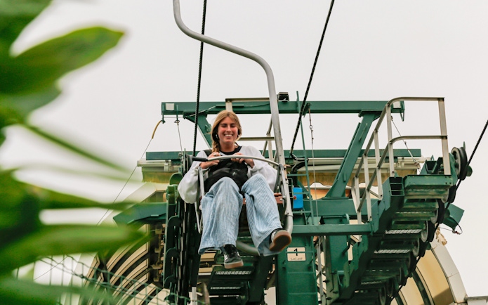 Tourist riding Monte Solaro Chair Lift in Anacapri, Italy.