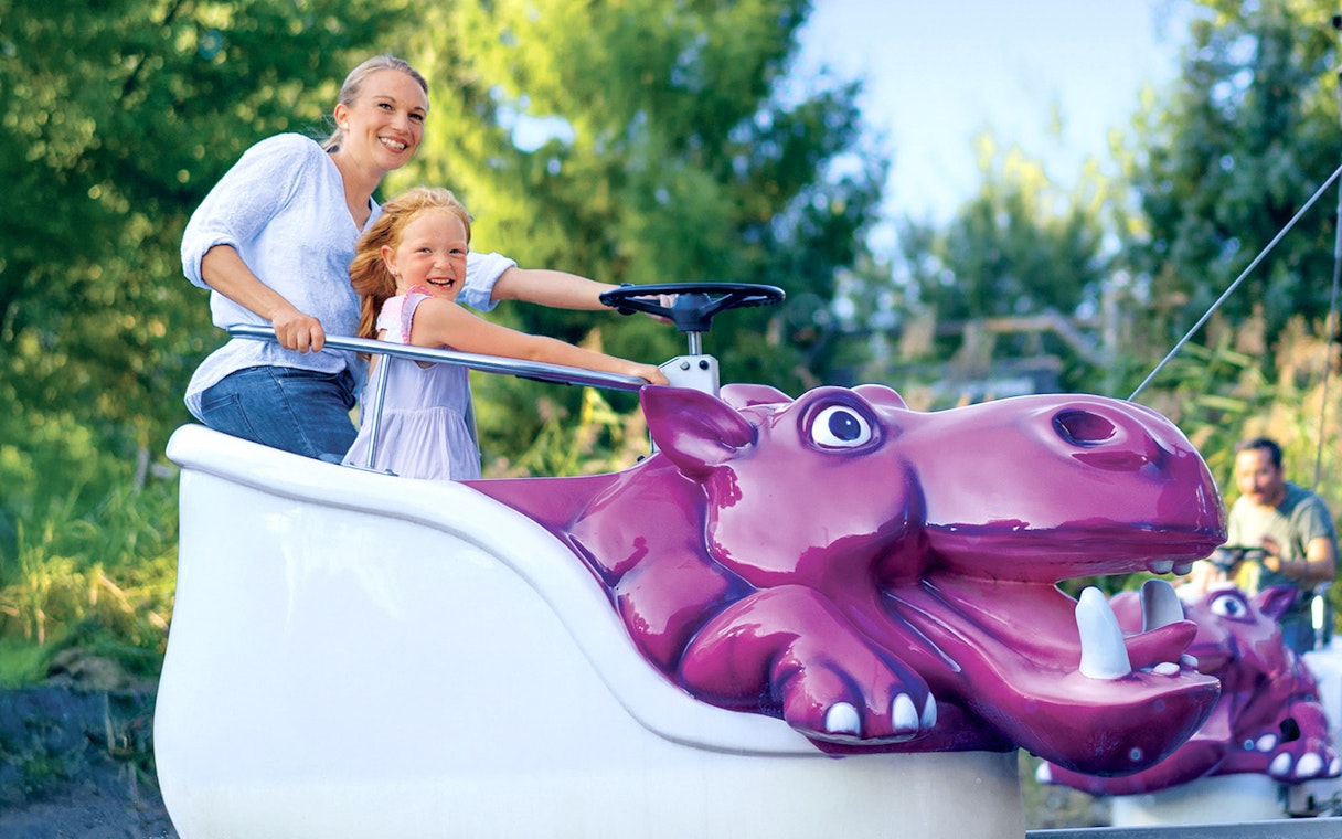 Visitors enjoying a hippo-themed ride at Ravensburger Spieleland.