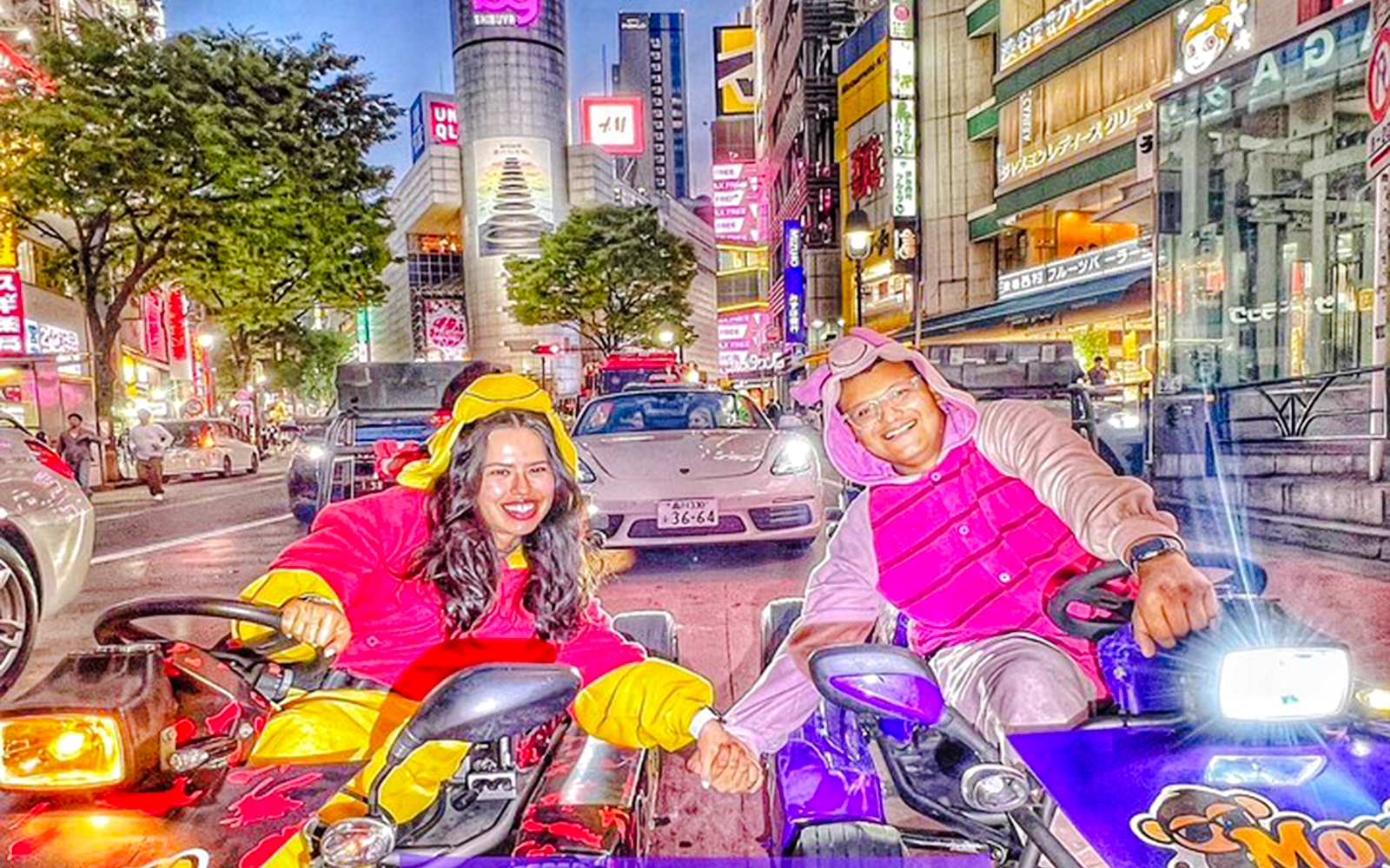 Tourists in themed costumes driving go-karts in Tokyo's vibrant city streets.