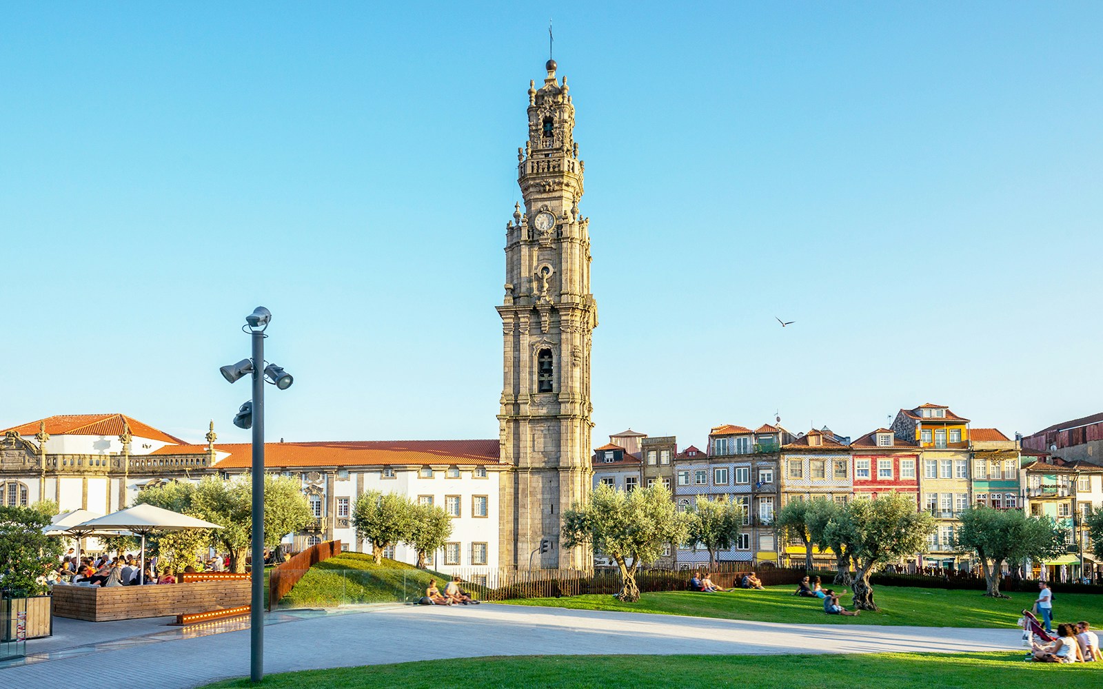 Clerigos Tower in Porto with surrounding park and people relaxing.