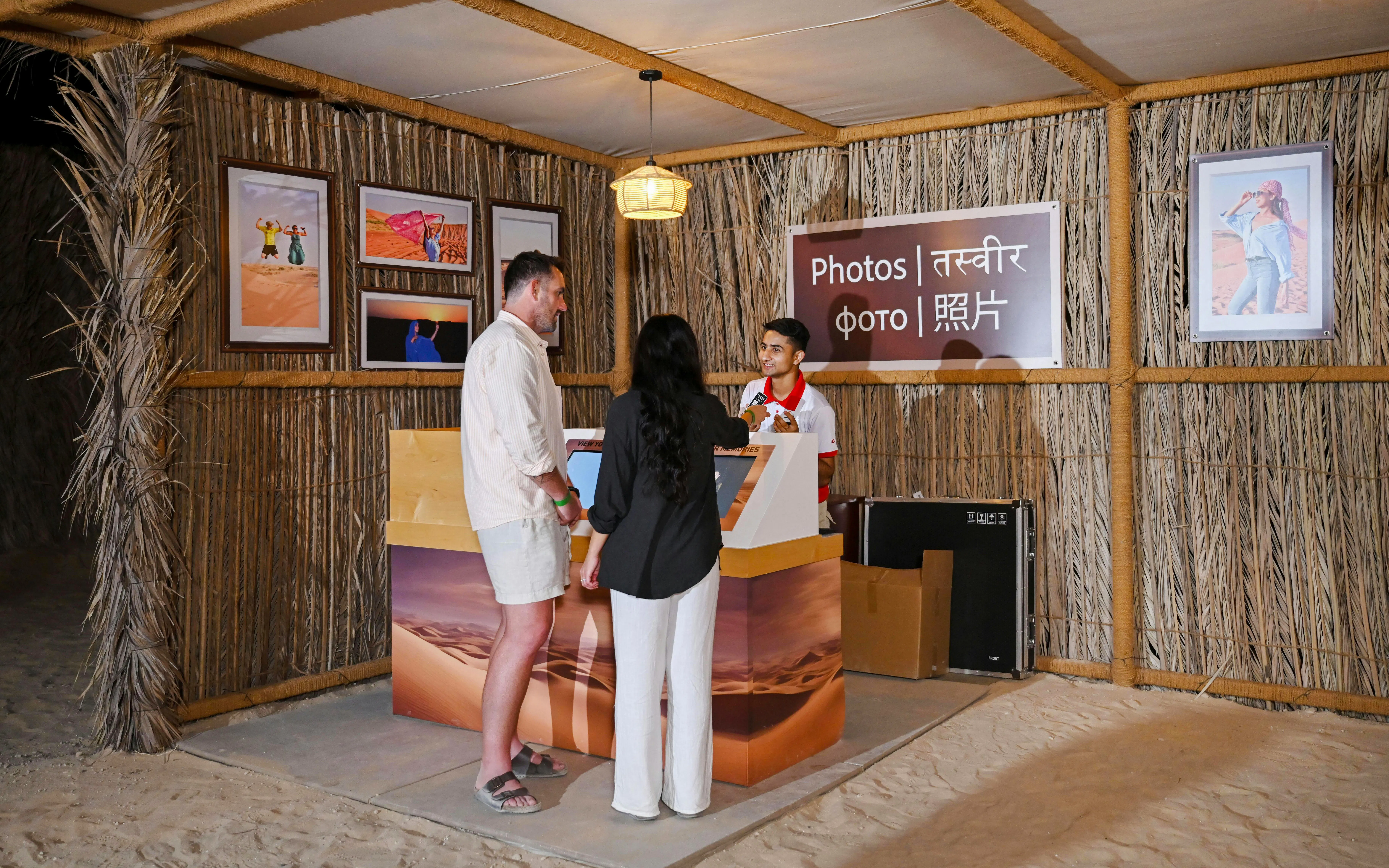 Photo booth at desert safari with visitors interacting with staff.