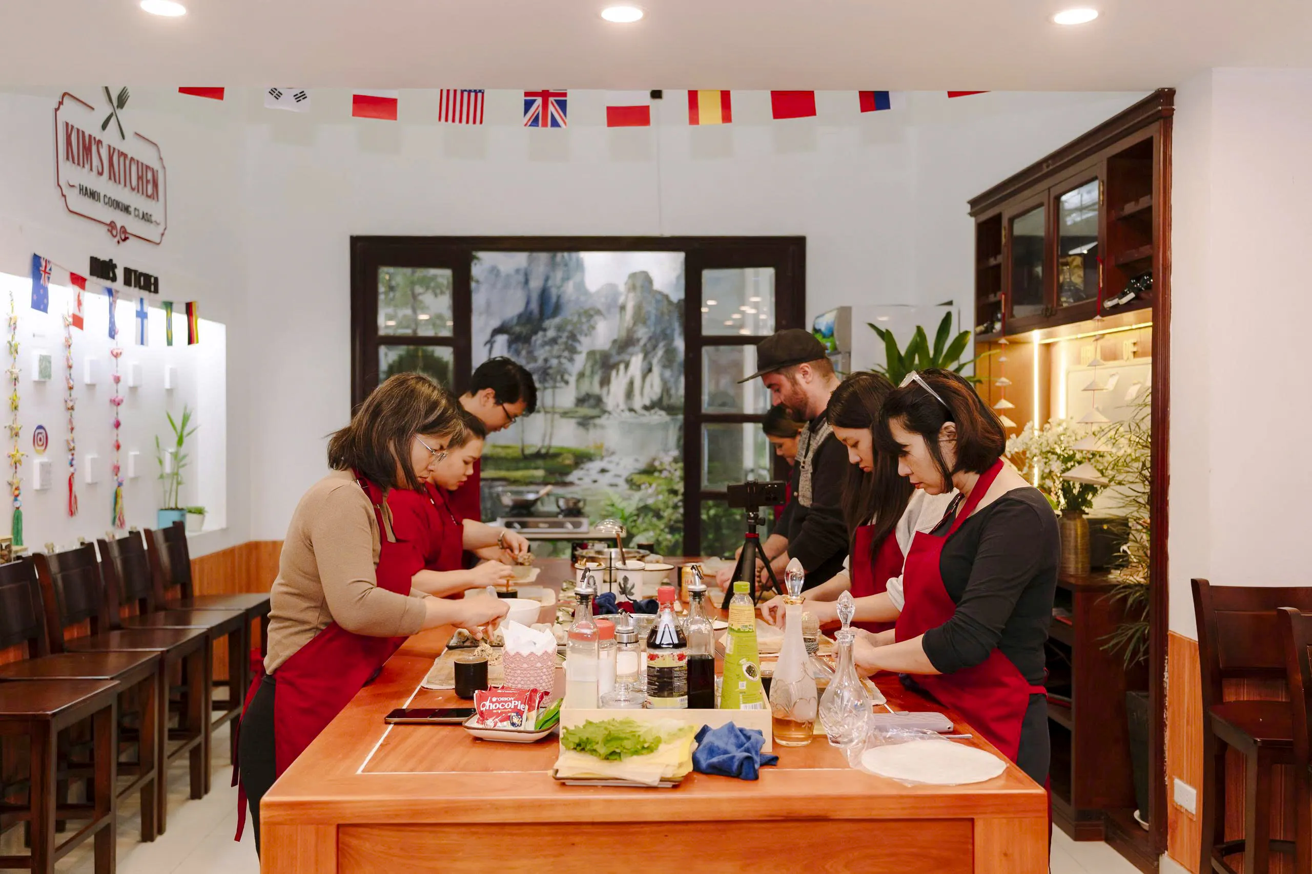 Participants preparing dishes in a Hanoi cooking class at Kim's Kitchen.