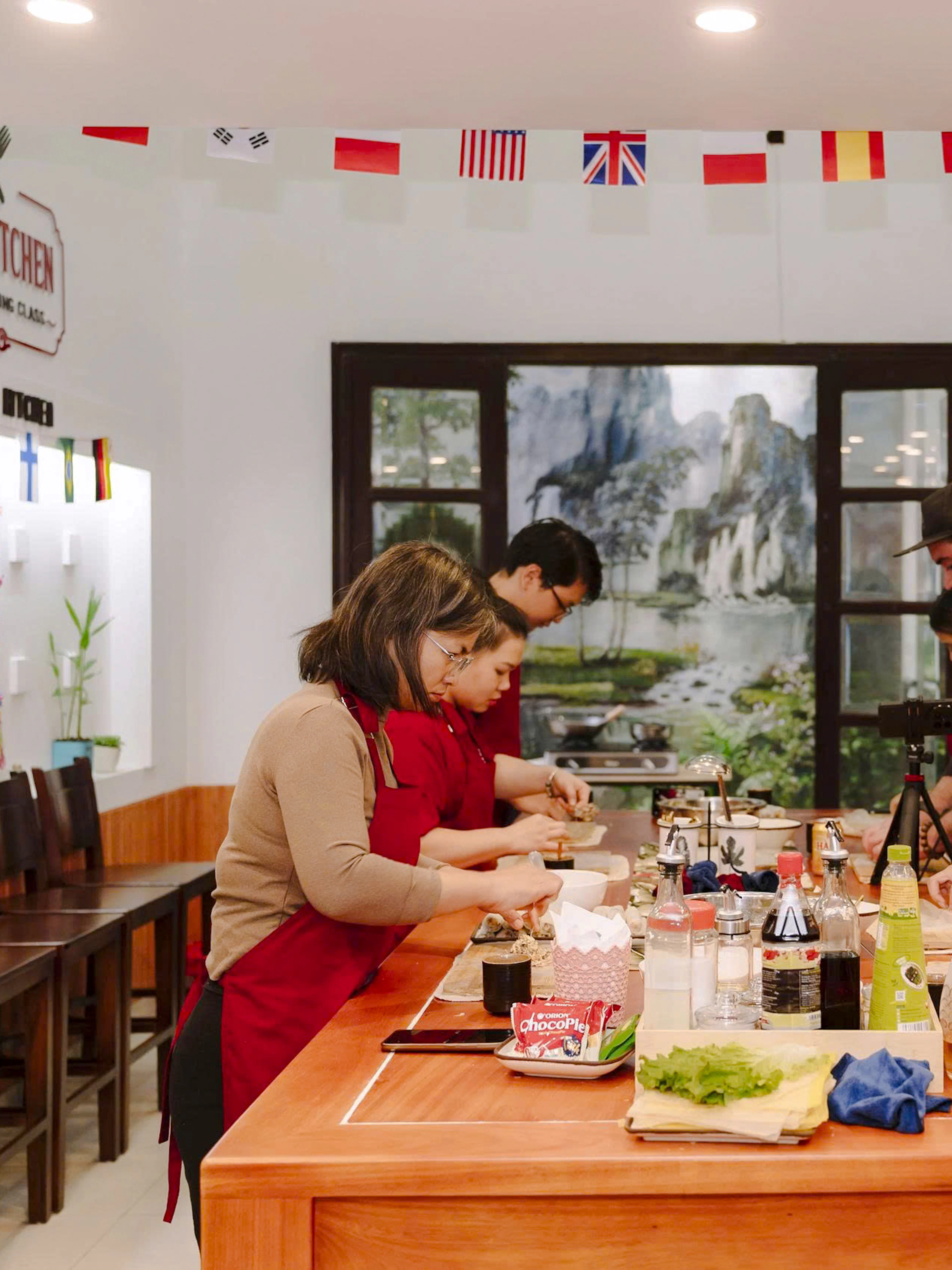 Participants preparing dishes in a Hanoi cooking class at Kim's Kitchen.