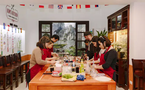 Participants preparing dishes in a Hanoi cooking class at Kim's Kitchen.