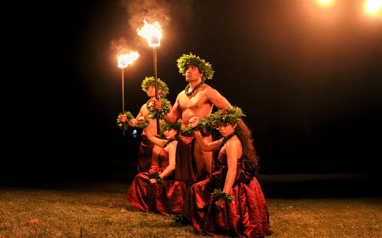 Traditional Hawaiian dancers with torches at Moana Luau, Hawaii.