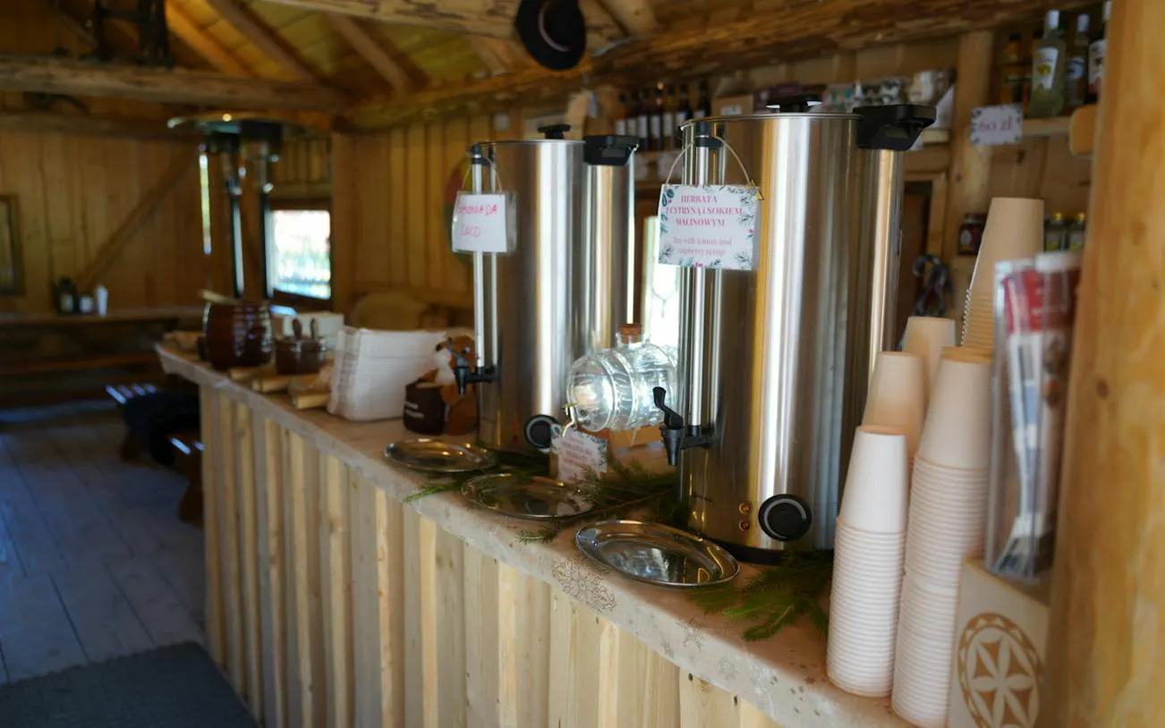 Hot beverage station in a rustic wooden cabin, part of the Zakopane tour experience.