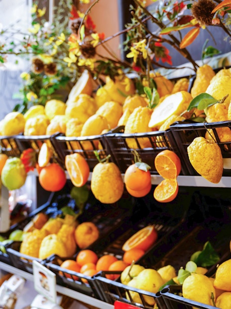 Lemons and citrus fruits on display in a Sorrento market during a guided tour.