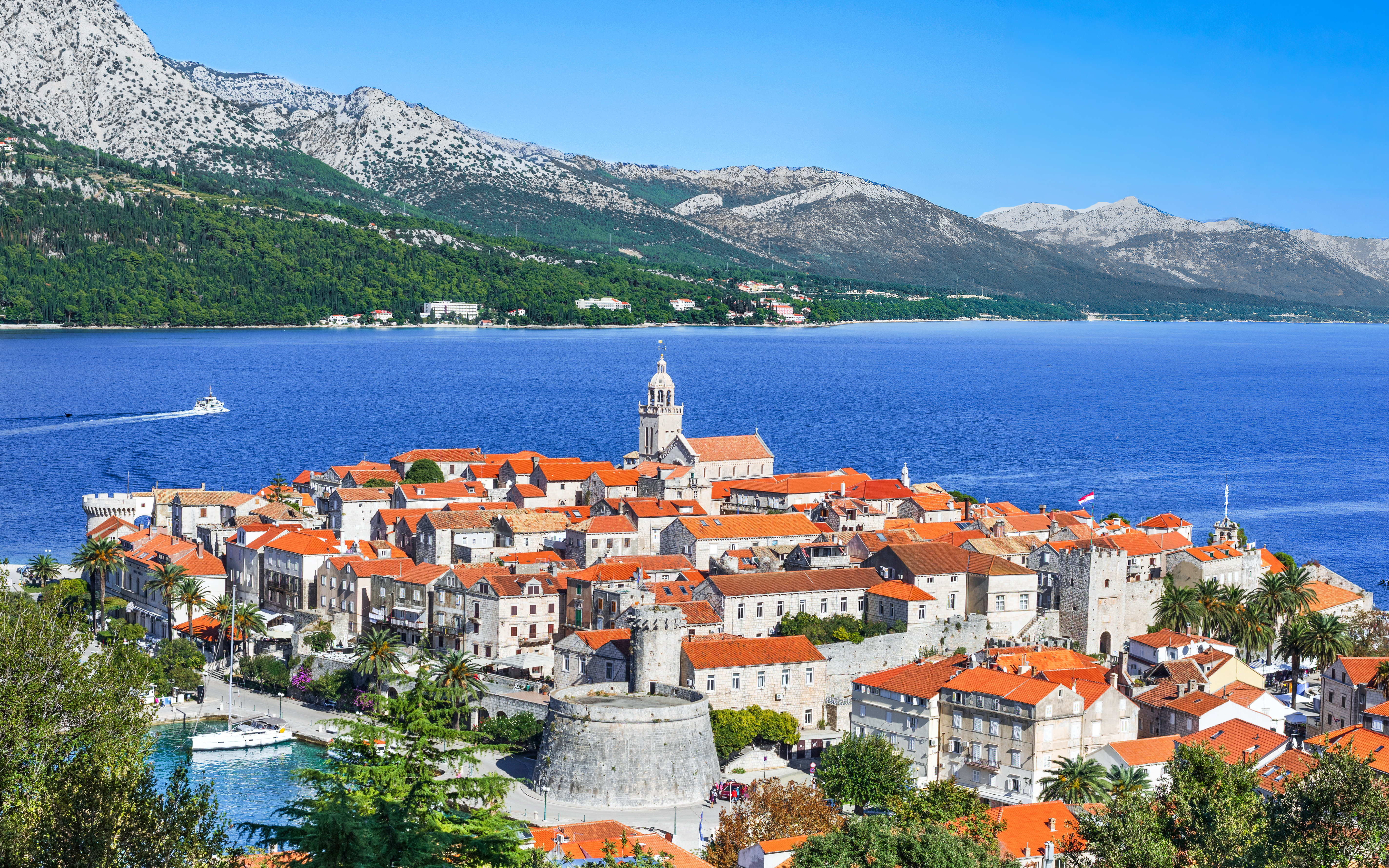 Korcula town with red-roofed buildings and bell tower on Korcula island, Dalmatia, Croatia.