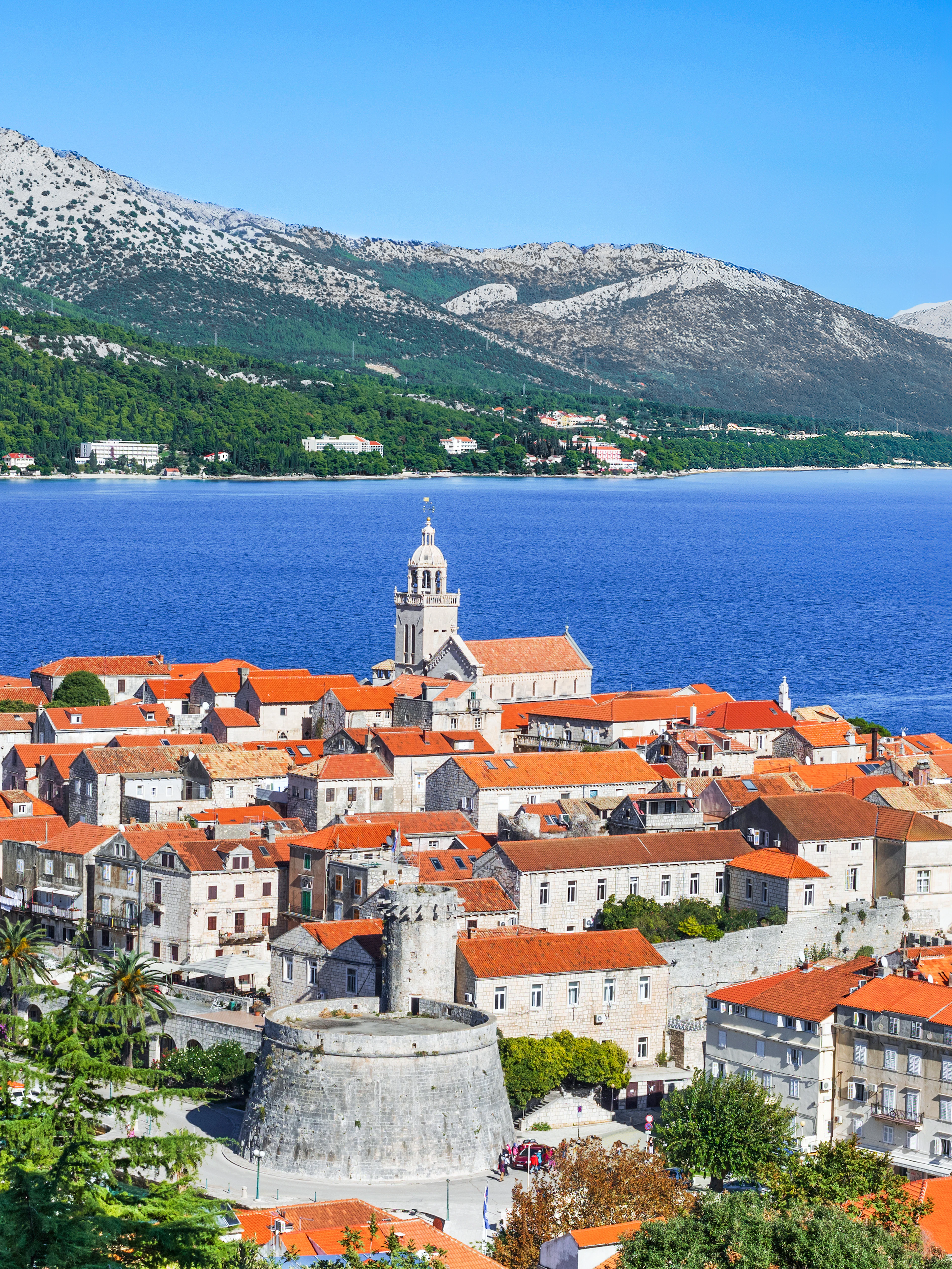 Korcula town with red-roofed buildings and bell tower on Korcula island, Dalmatia, Croatia.