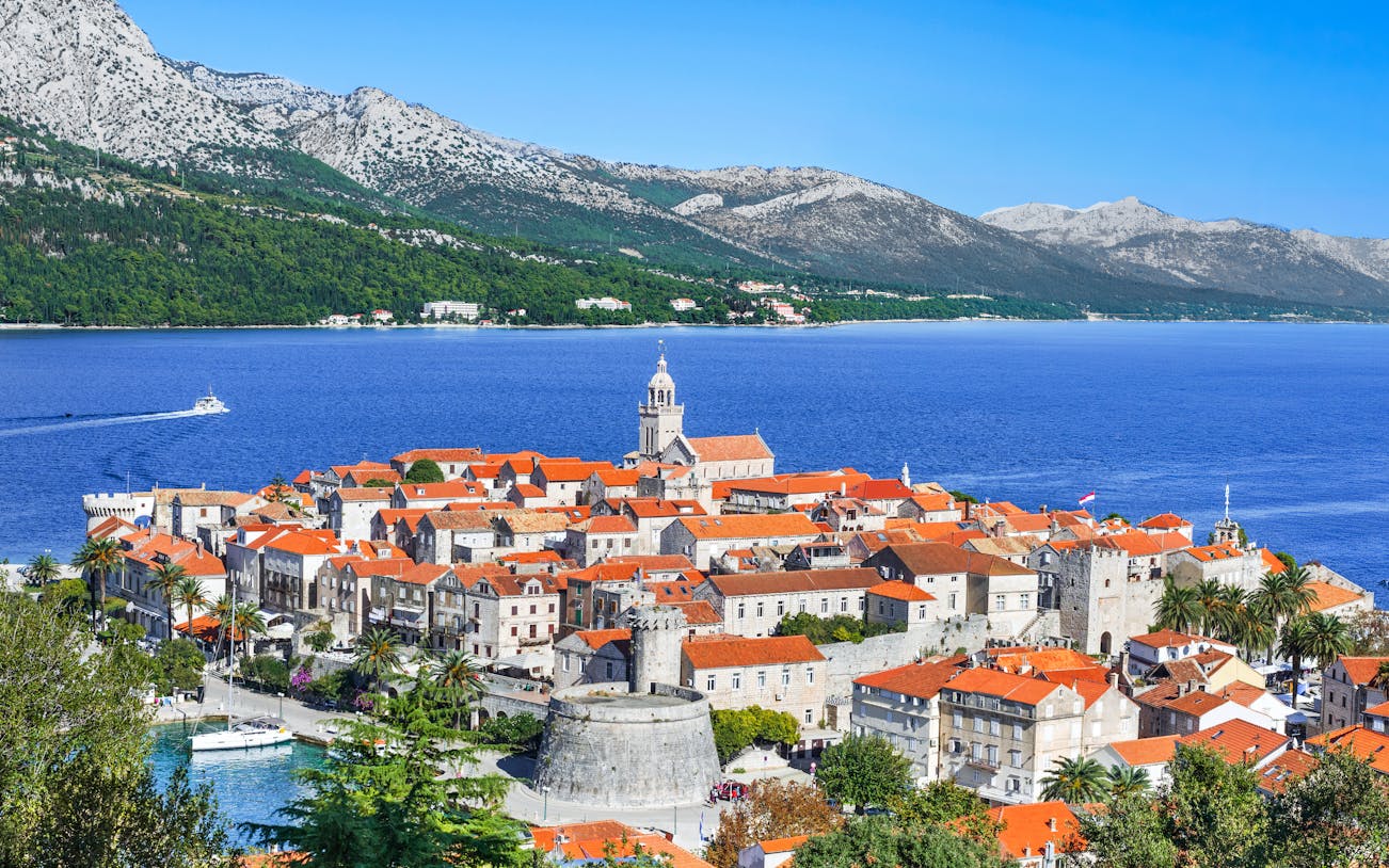 Korcula town with red-roofed buildings and bell tower on Korcula island, Dalmatia, Croatia.