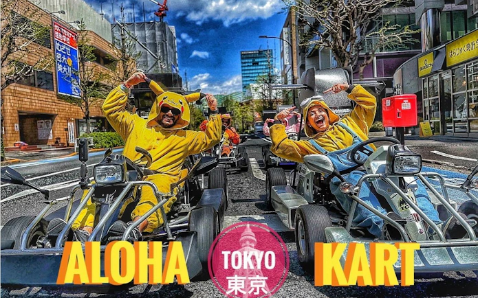 Tourists in colorful costumes go-karting on Tokyo streets.
