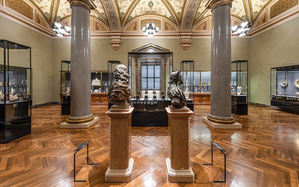Art Chamber with sculptures and display cases inside Kunsthistorisches Museum Vienna.