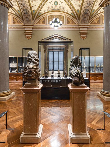 Art Chamber with sculptures and display cases inside Kunsthistorisches Museum Vienna.