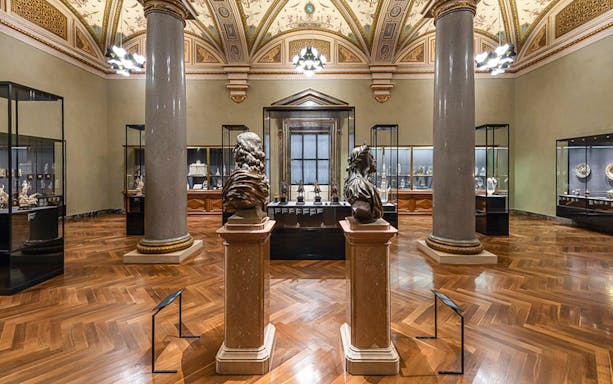 Art Chamber with sculptures and display cases inside Kunsthistorisches Museum Vienna.