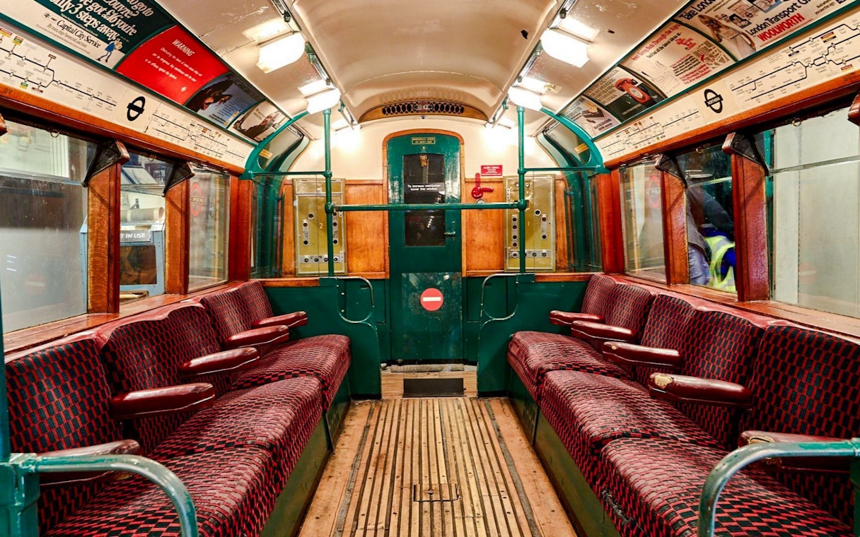 Interior of a vintage train carriage at the London Transport Museum.