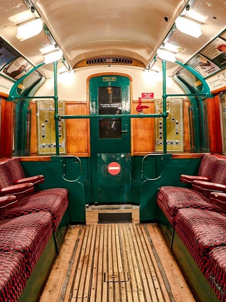 Interior of a vintage train carriage at the London Transport Museum.
