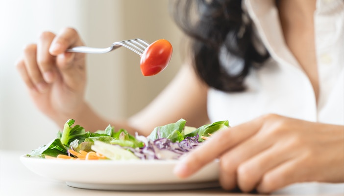 Fresh garden salad with mixed greens, cherry tomatoes, cucumbers, and red onions.