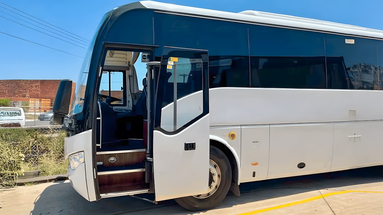 Great Ocean Road Reverse Tour bus on scenic coastal route, Melbourne, Australia.