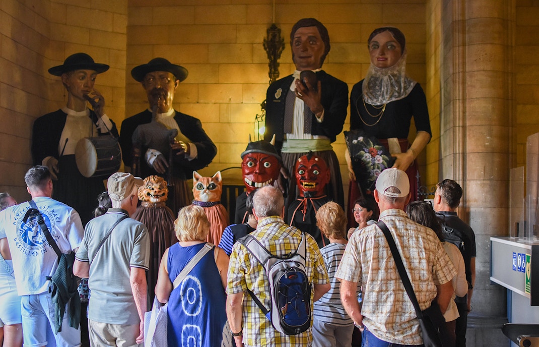 Visitors exploring the interior of the Cathedral of Palma, Mallorca, with intricate Gothic architecture.