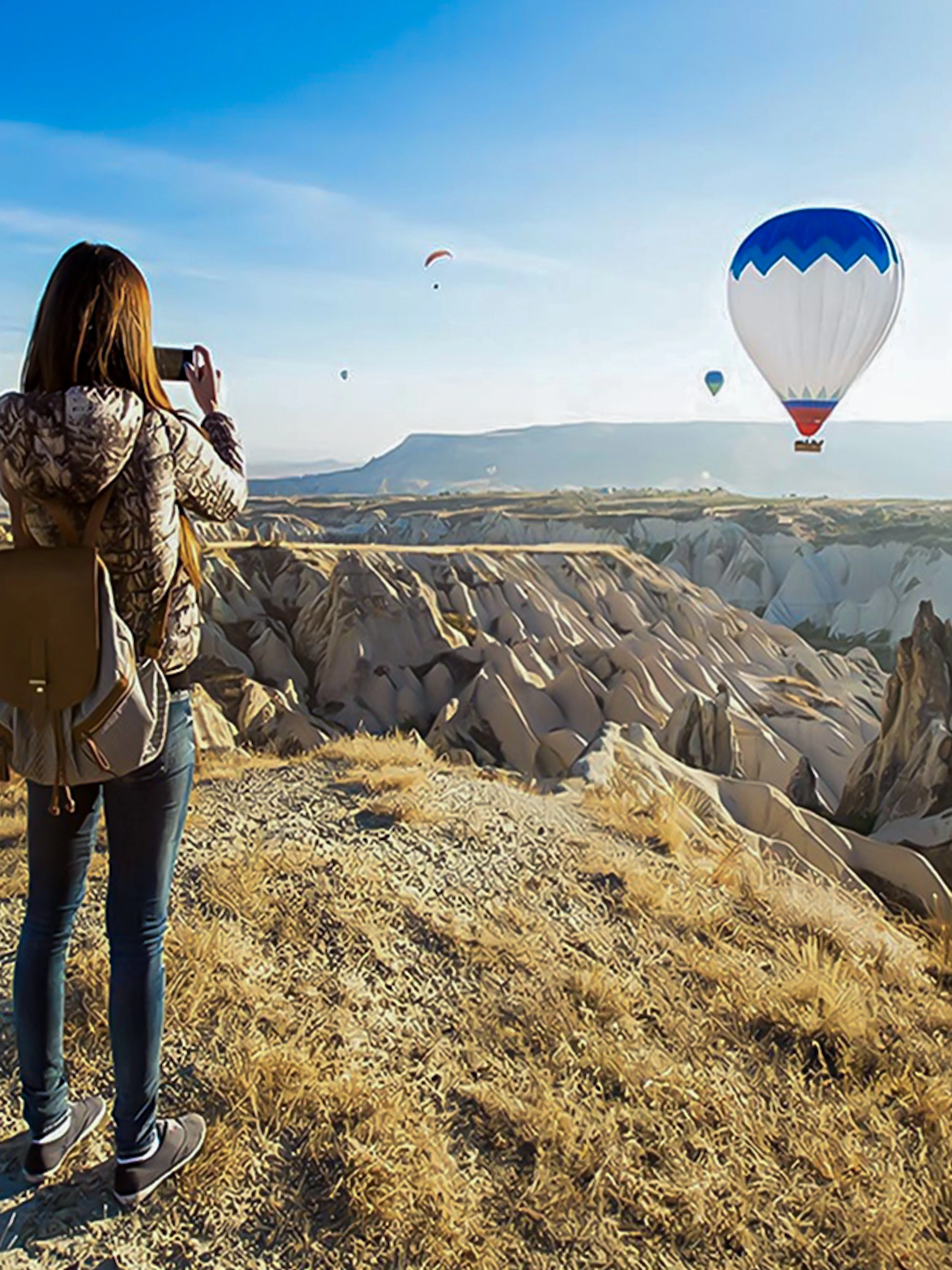 Guest photographing hot air balloons over Gerome Valley, Cappadocia.