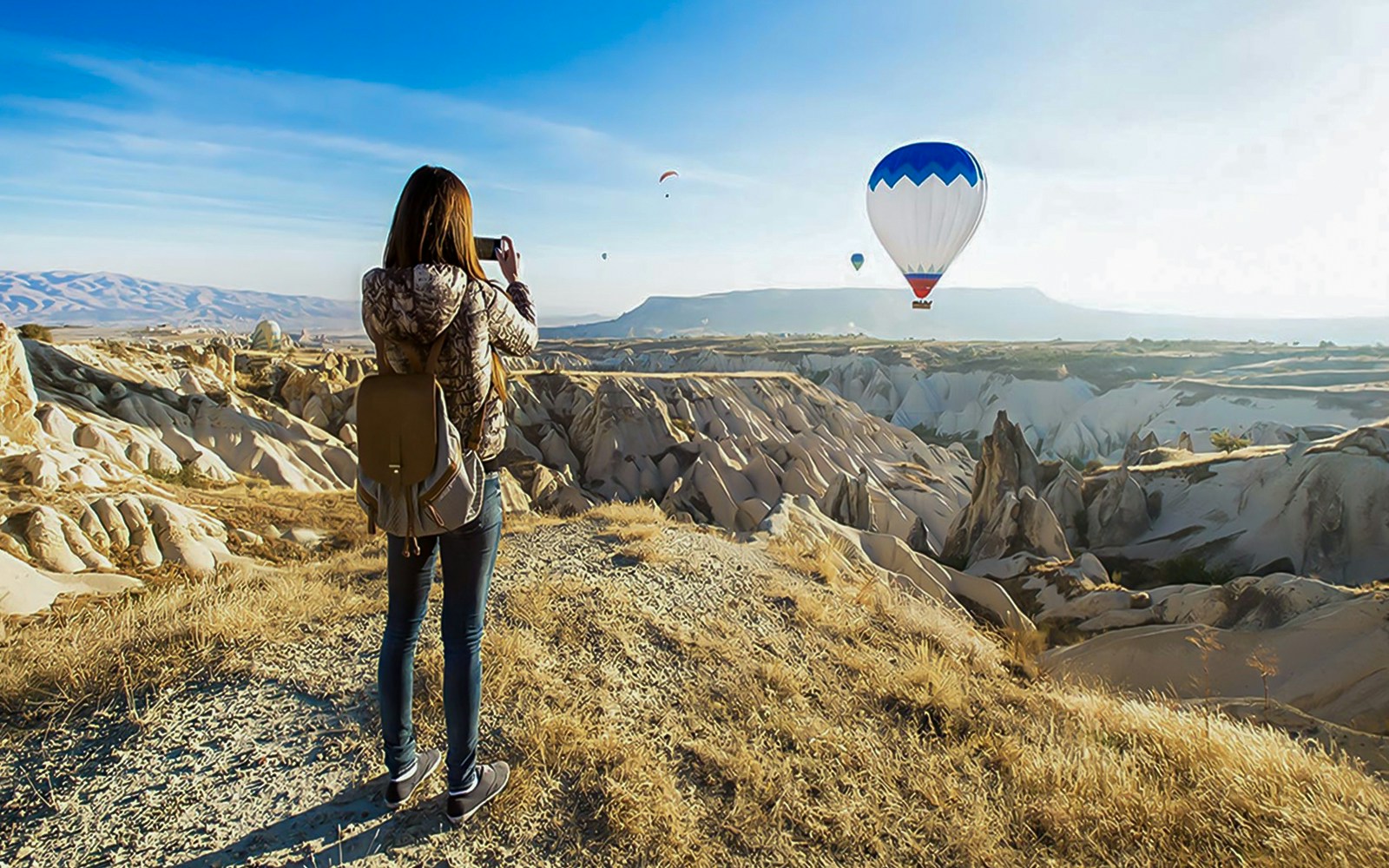 Guest photographing hot air balloons over Gerome Valley, Cappadocia.