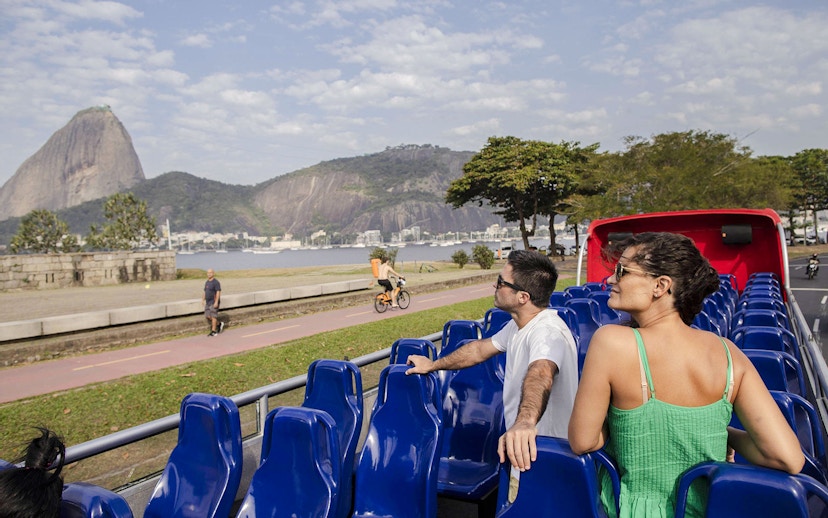 Open-top bus tour in Rio de Janeiro with view of Sugarloaf Mountain.