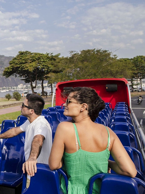 Open-top bus tour in Rio de Janeiro with view of Sugarloaf Mountain.