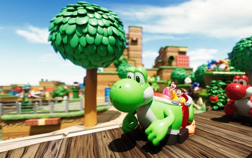 Visitors enjoying Yoshi's Adventure ride at Universal Studios Japan.