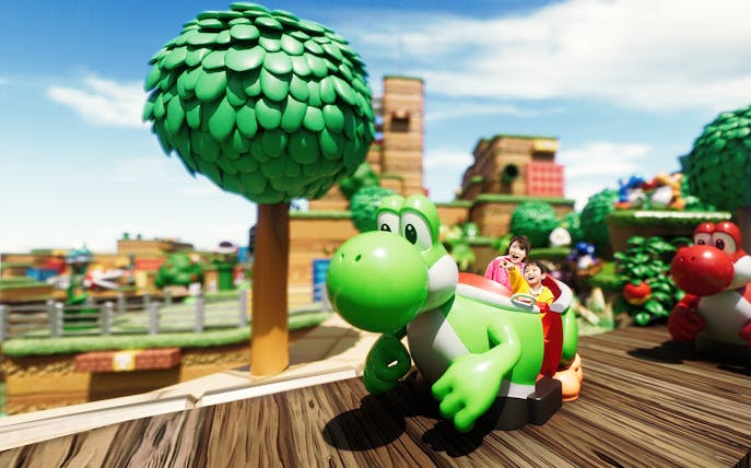 Visitors enjoying Yoshi's Adventure ride at Universal Studios Japan.