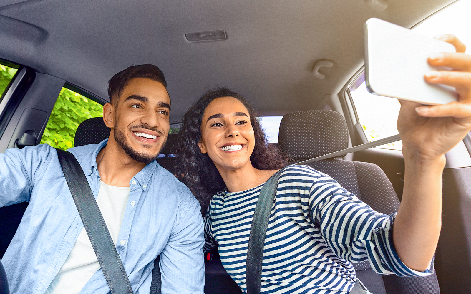 Happy couple in summer loose clothes in car driving to Castel Sant Angelo.