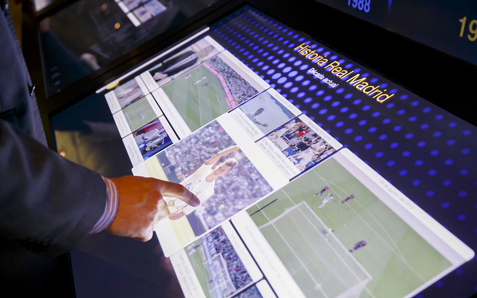 Interactive touchscreen display at Santiago Bernabeu Stadium showcasing Real Madrid history.