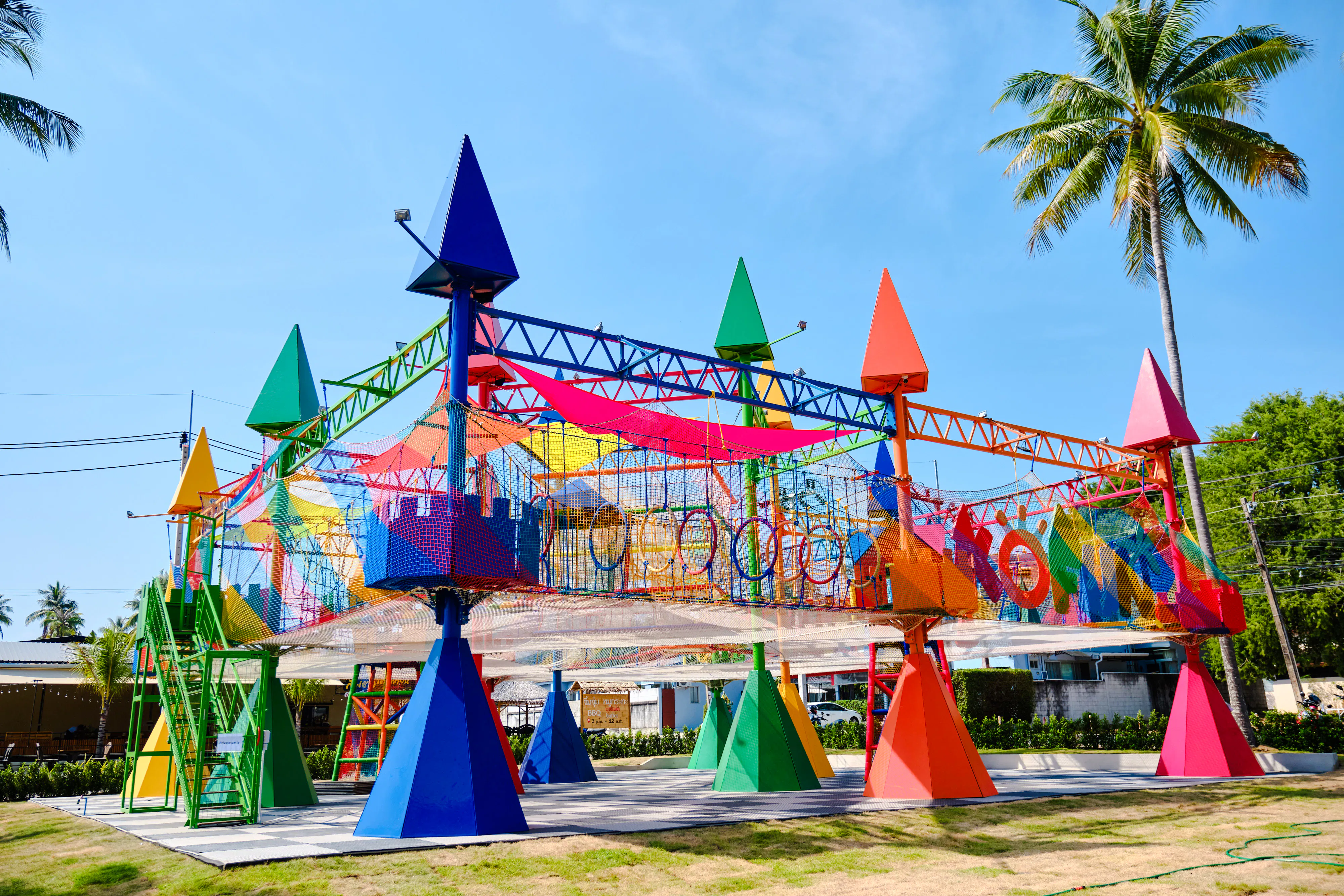 Colorful rope park structure with climbing nets and obstacles at Ko Fun Kids Rope Park, Phuket.