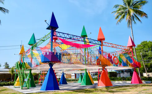 Colorful rope park structure with climbing nets and obstacles at Ko Fun Kids Rope Park, Phuket.