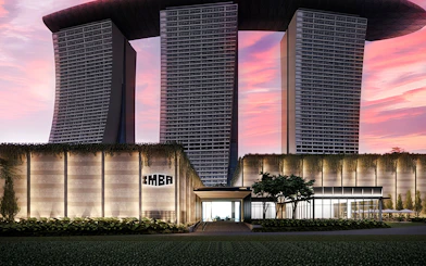 Modern architectural building with IMBA sign at sunset.