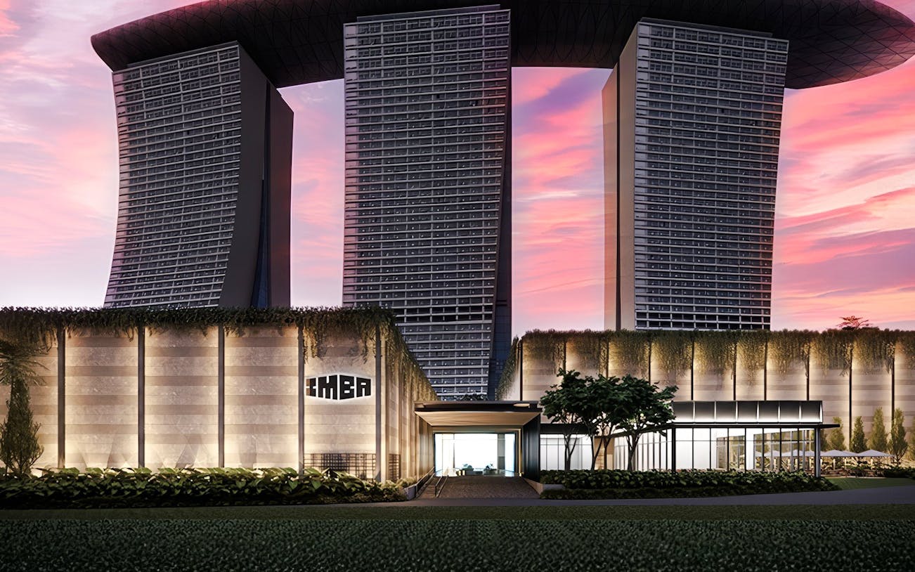 Modern architectural building with IMBA sign at sunset.