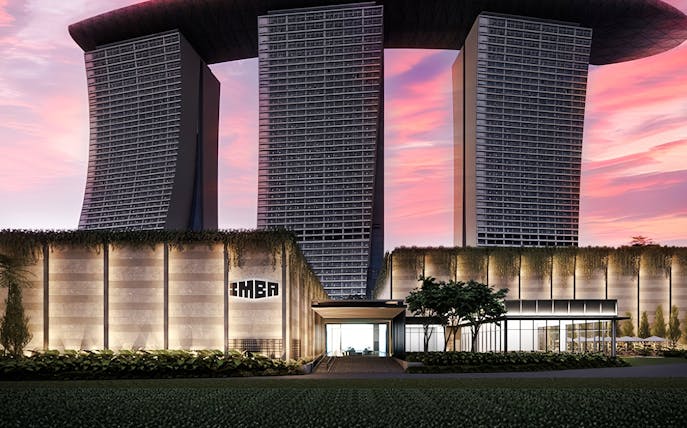 Modern architectural building with IMBA sign at sunset.